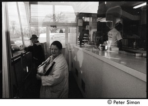 Customers at Joe Gile's Bungalow, a popular take-away restaurant in Lawrence: cook behind the counter is wearing a Joe Gile's jacket