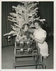 Monica Vermeulen and her doll with physical therapist at Christmas party