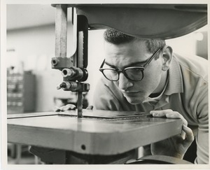 Donald Meisler operating a bandsaw