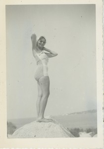 Bernice Kahn posing on a rock overlooking a harbor