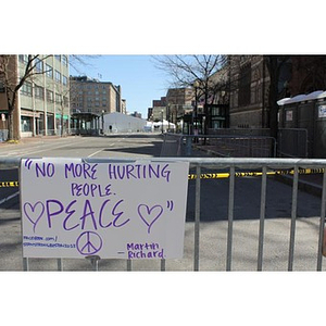 "No More Hurting People" sign left at Boston Marathon memorial