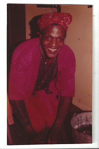 A Photograph of Marsha P. Johnson Cleaning and Wearing an All Red Outfit