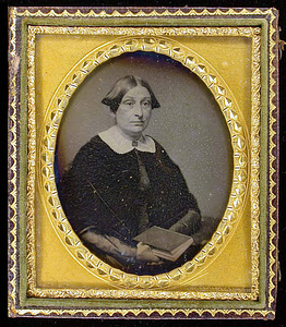 Half-length portrait of an adult female holding a book