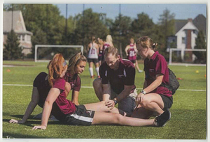 Athletic trainers tending player