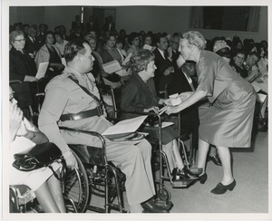 Mrs. Frank Russell handing prize to client in audience at Institute Day