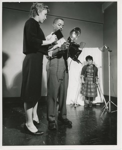 Woman using crutches being photographed