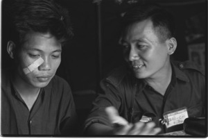 Vietcong Platoon leader Tran Huy Nho with interpreter.