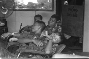 Vietnamese rangers in barbershop on Han Giang Boulevard, resting after tough fighting; Saigon.