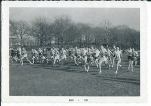 Cross country runners running across field (December, 1958)
