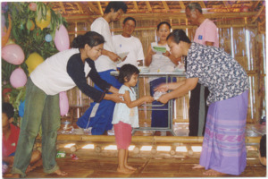 A photograph of Thin Thin Avng receiving an award for kindergarten in Nu Poe refugee camp, Thailand, 2007