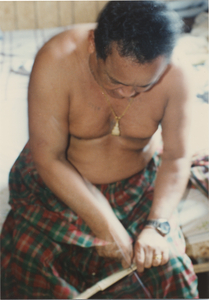 Basket Making: Em Yung cuts notches into the ends of the pole, 1987