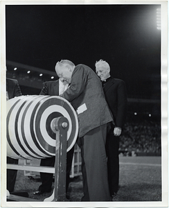 Mayor John F. Collins pulling a ticket from a raffle barrel at Fenway Park