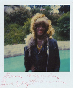 A Photograph of Marsha P. Johnson With Yellow Tinsel in Her Hair, Standing in a Backyard with a Pool