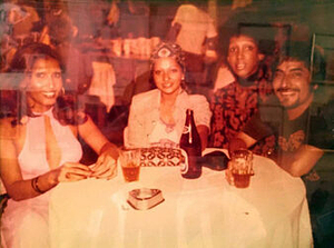 A Photograph of Marlow Monique Dickson and Others Posing Around a Table