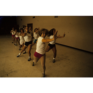 Women doing dance moves in a gym