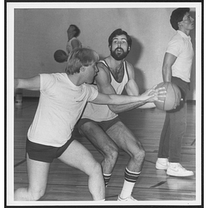 Men playing basketball with each other