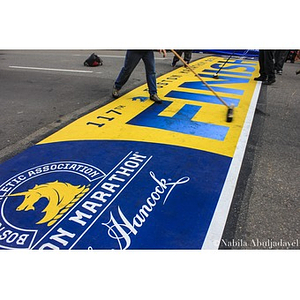 Workers clean up the 2013 Boston Marathon finish line area on the morning of the race