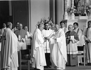 Archbishop Bernard F. Law reading at altar with unidentified priests