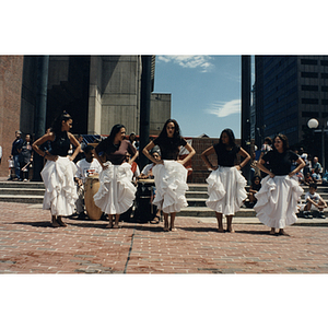 Five women dance barefoot in City Hall Plaza