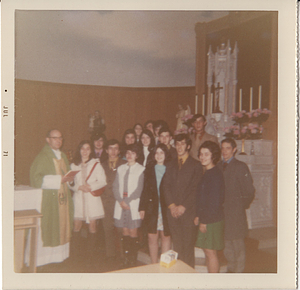 Youth group poses with Fr. John Silva at altar