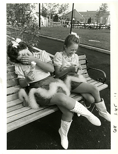 Maria Souza and Debbie Mello share a giggle on bench