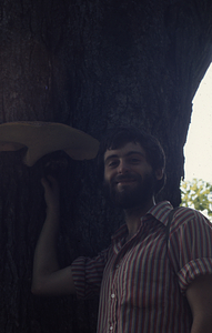 Claude dePamphilis and large artist's fungus on sugar maple tree.