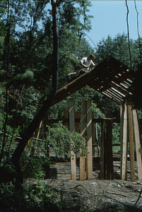 Peter Jensen working on roof ridge on the Moon Barn at the 2 August 1975 barn raising.