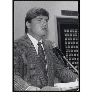 A male staffer speaking from the podium