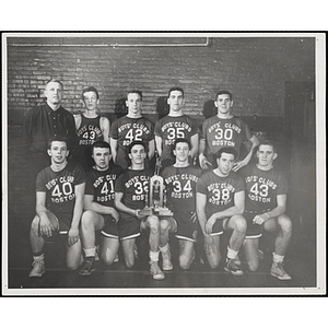 Group portrait of a basketball team with their trophy that reads, "Frederic Cameron Church 1958 New England Boys Clubs"