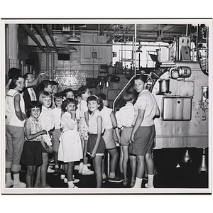 A group of girls turn toward the camera during a tour of a Hood plant during a day camp outing