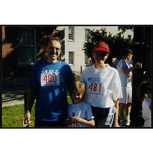 A man and a woman pose with a boy at the Battle of Bunker Hill Road Race