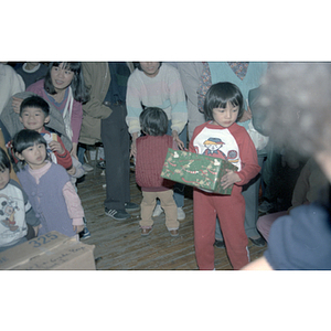 Children and gifts at a Chinese Progressive Association anniversary event