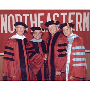 Eugene Reppucci, Jr. and Harvey Krentzman, honorary degree recipients, pose with Chairman of the Board of Trustees George Matthews and President Curry