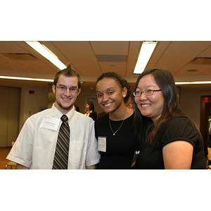 Jordan Munson, Melanie Arvajo, and Qinrui Pang pose together at the Torch Scholars dinner
