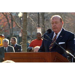 Richard Egan stands at the podium at the Veterans Memorial dedication ceremony