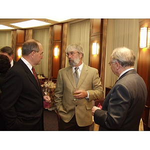 Robert E. DiCenso (CBA '62), left, and guests with drinks conversing prior to the College of Business Administration's Distinguished Service Awards ceremony