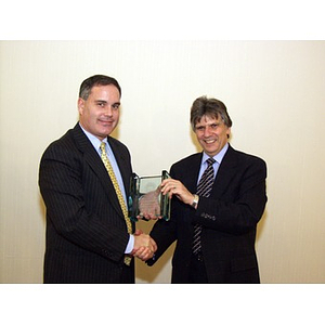 Joseph Malarny, CBA '82, accepts College of Business Administration's Distinguished Service Award from Dr. Ira R. Weiss (right)