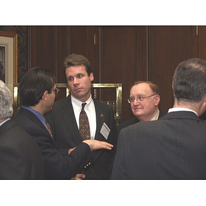 Three men talking at gala dinner to honor John Hatsopoulos