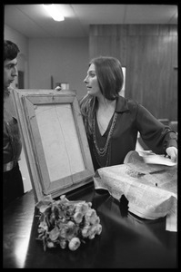 Judy Collins unwrapping a painting