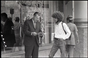 Free Spirit Press crew member discussing the magazine with a man in a business suit