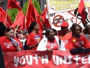 Marchers with Youth United for Change banner, marching in the streets to oppose the war in Iraq