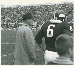 Victor M. Fusia watching with football player