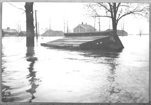Building toppled and partially submerged by floodwaters