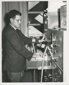 Frank Lettiere looking through a filing cabinet