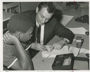 Ronald Borsari teaches Robert Adams supermarket checking at TOWER training