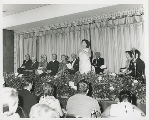 Group watching woman on stage