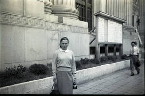 Young woman standing in front of building
