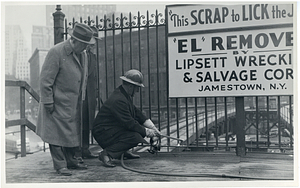 First cut for removal of Atlantic Avenue Elevated at South Station, Governor Saltonstall using torch, Colonel Sullivan and Mr. Whiting at left