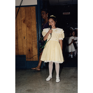 A young girl speaks into a microphone during events for the Festival Puertorriqueño
