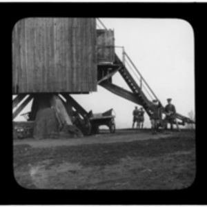 Men and wagons beneath the windmill